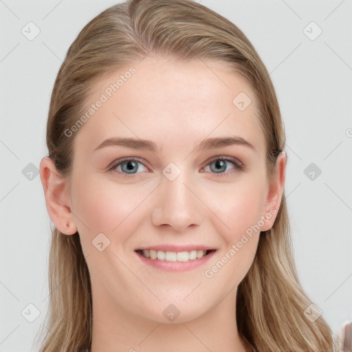 Joyful white young-adult female with long  brown hair and blue eyes