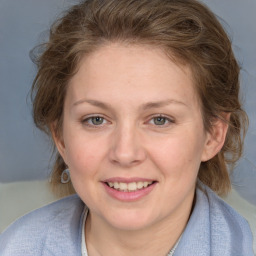 Joyful white young-adult female with medium  brown hair and blue eyes