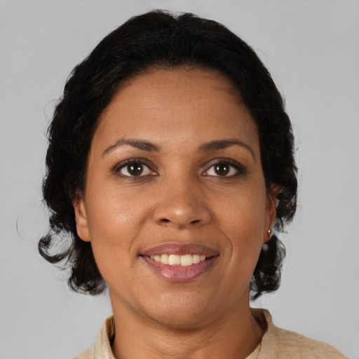 Joyful black adult female with medium  brown hair and brown eyes