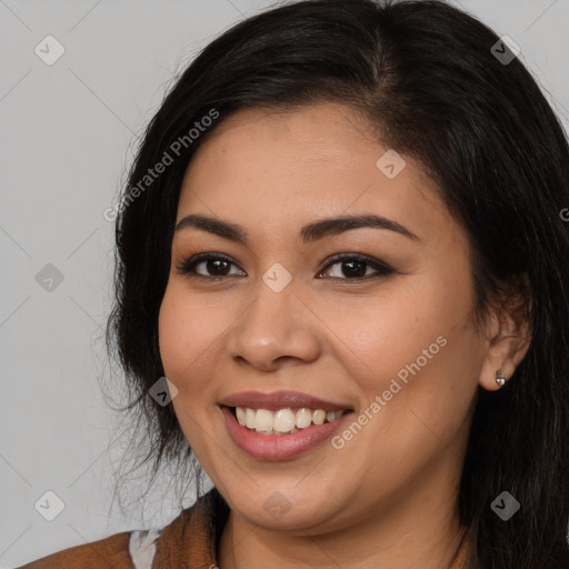 Joyful latino young-adult female with long  black hair and brown eyes