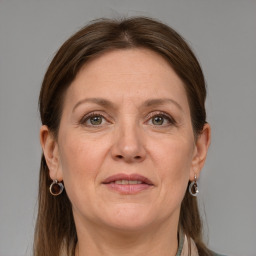 Joyful white adult female with medium  brown hair and grey eyes