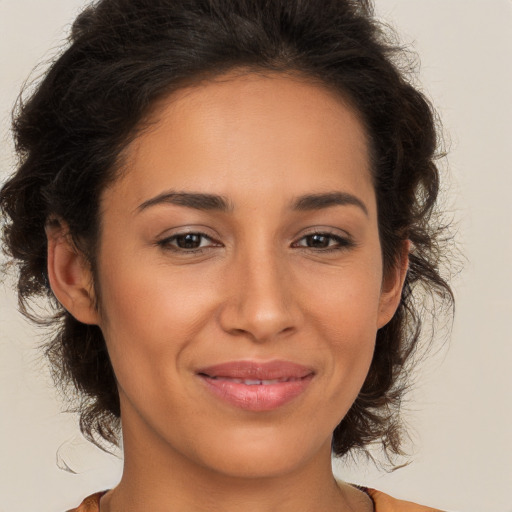 Joyful latino young-adult female with medium  brown hair and brown eyes