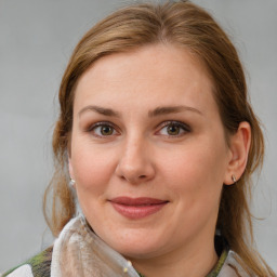 Joyful white adult female with medium  brown hair and blue eyes