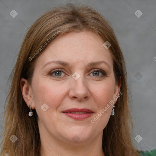 Joyful white adult female with long  brown hair and grey eyes