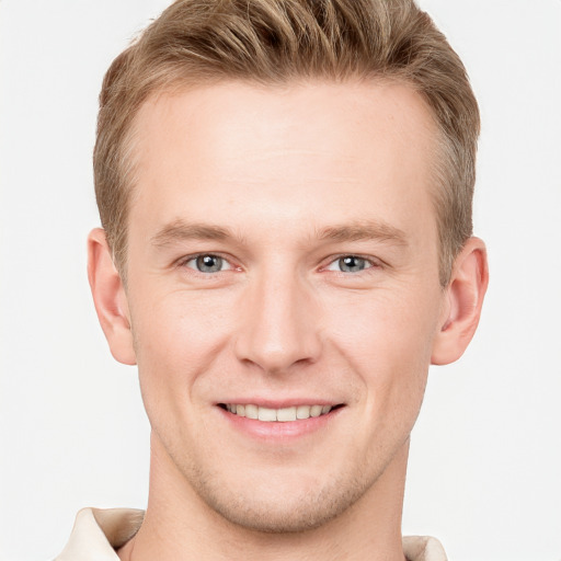 Joyful white young-adult male with short  brown hair and blue eyes