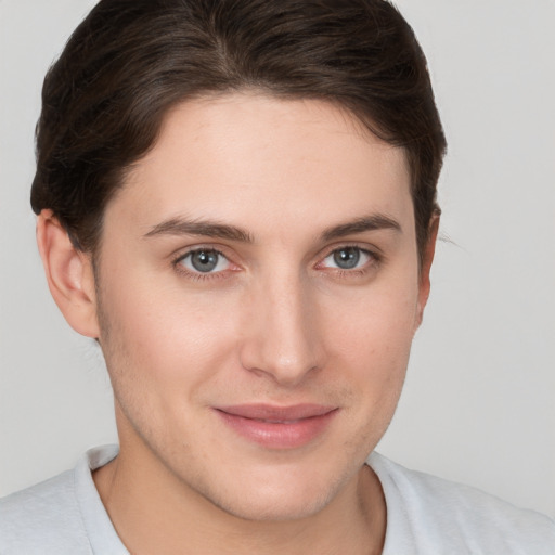 Joyful white young-adult female with short  brown hair and grey eyes