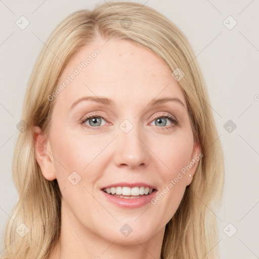 Joyful white young-adult female with long  brown hair and blue eyes