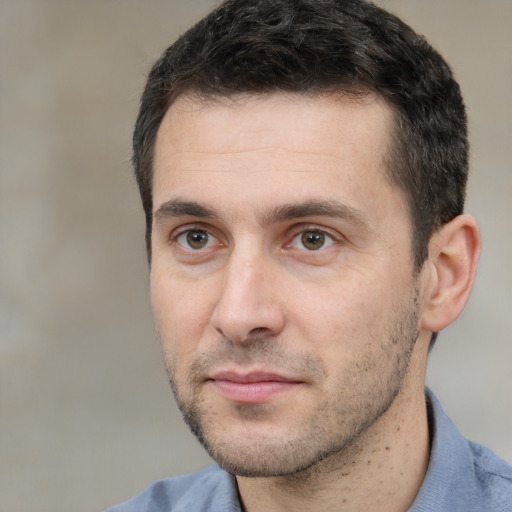 Joyful white young-adult male with short  black hair and brown eyes