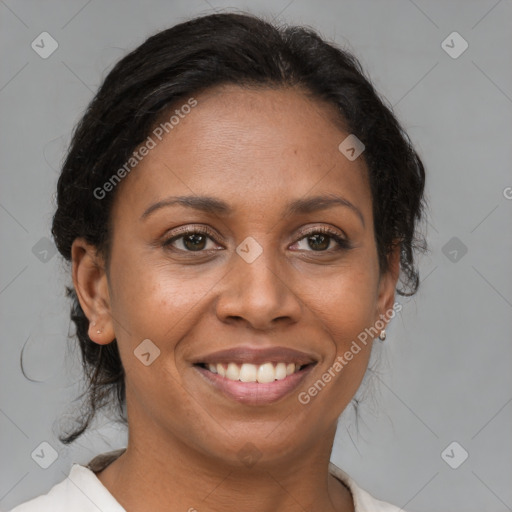 Joyful black adult female with medium  brown hair and brown eyes