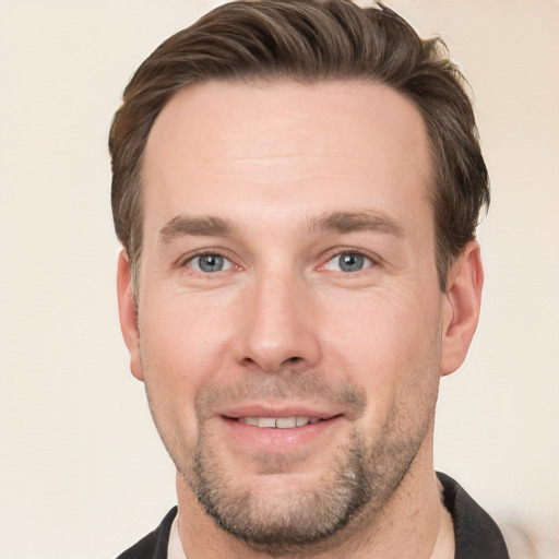 Joyful white adult male with short  brown hair and grey eyes