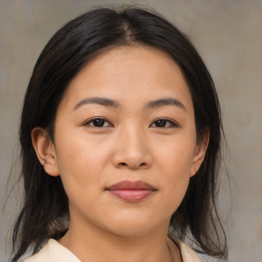 Joyful asian young-adult female with medium  brown hair and brown eyes