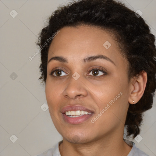 Joyful black young-adult female with medium  brown hair and brown eyes