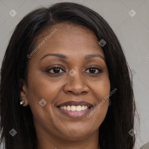 Joyful black young-adult female with long  brown hair and brown eyes