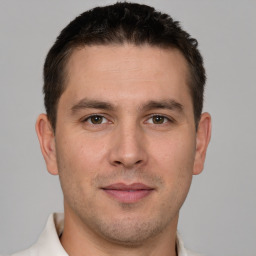 Joyful white young-adult male with short  brown hair and brown eyes