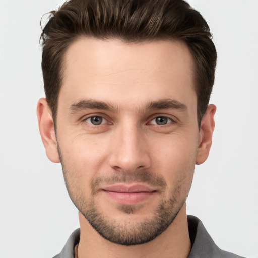 Joyful white young-adult male with short  brown hair and brown eyes