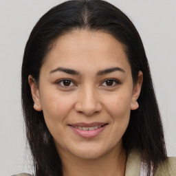 Joyful latino young-adult female with medium  brown hair and brown eyes