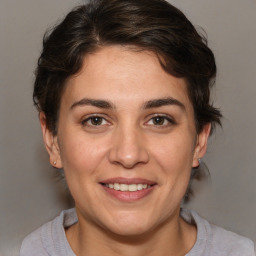 Joyful white adult female with medium  brown hair and brown eyes