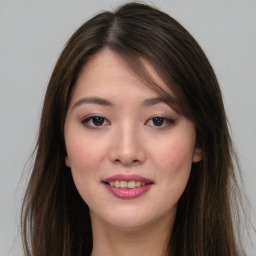 Joyful asian young-adult female with long  brown hair and brown eyes