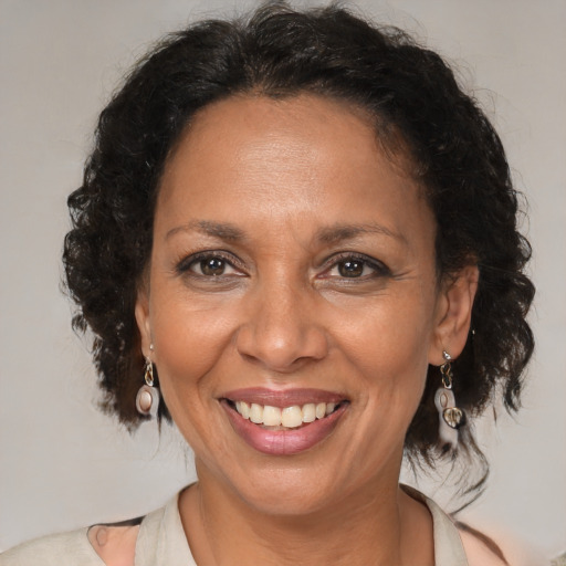 Joyful black adult female with medium  brown hair and brown eyes