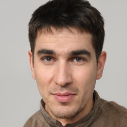 Joyful white adult male with short  brown hair and brown eyes