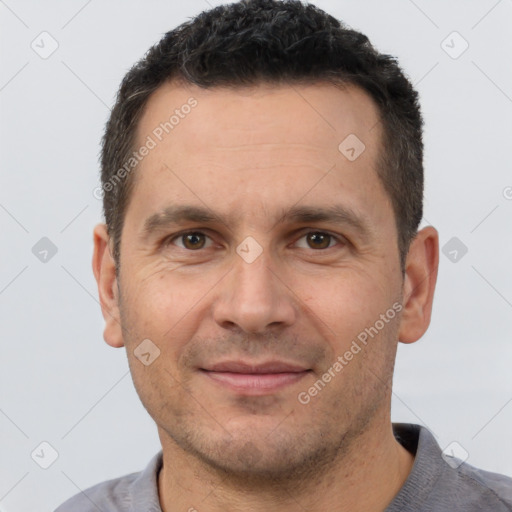 Joyful white adult male with short  brown hair and brown eyes