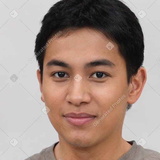 Joyful asian young-adult male with short  brown hair and brown eyes