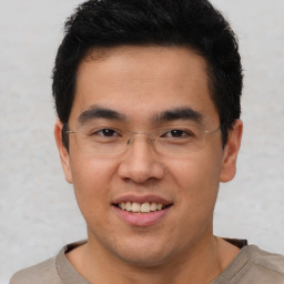 Joyful latino young-adult male with short  brown hair and brown eyes