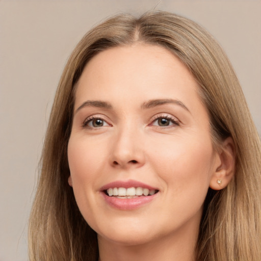 Joyful white young-adult female with long  brown hair and brown eyes