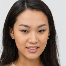 Joyful asian young-adult female with long  brown hair and brown eyes