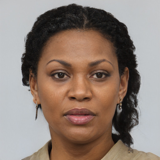 Joyful black adult female with short  black hair and brown eyes
