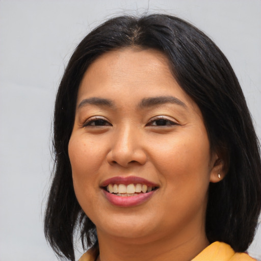 Joyful asian young-adult female with long  brown hair and brown eyes