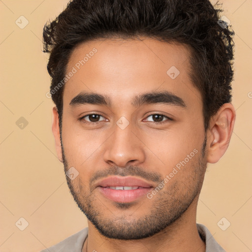 Joyful latino young-adult male with short  brown hair and brown eyes