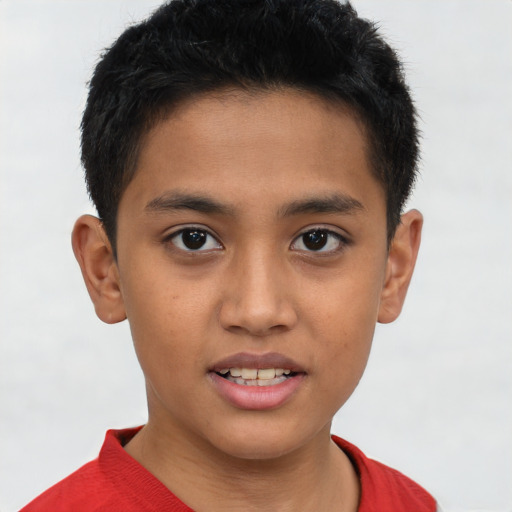 Joyful asian child male with short  brown hair and brown eyes