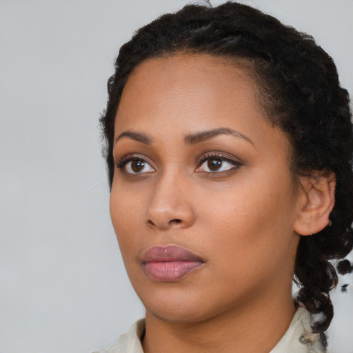 Neutral black young-adult female with medium  black hair and brown eyes