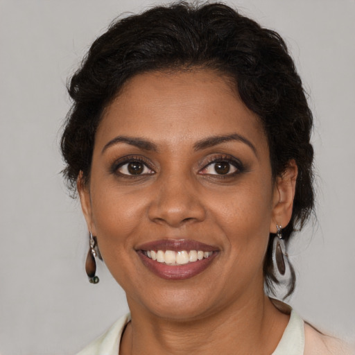 Joyful black young-adult female with medium  brown hair and brown eyes