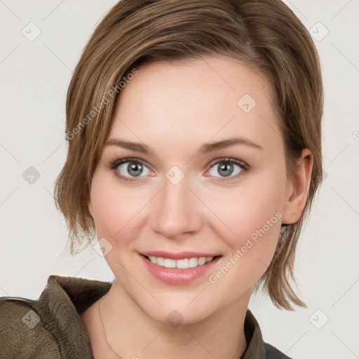 Joyful white young-adult female with medium  brown hair and grey eyes