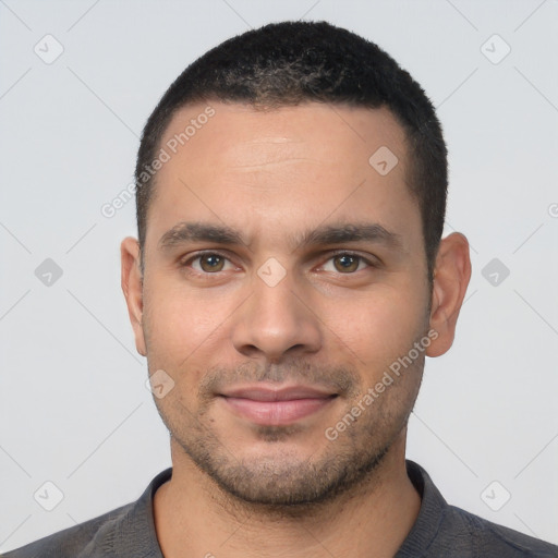 Joyful white young-adult male with short  black hair and brown eyes