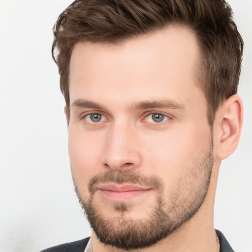 Joyful white young-adult male with short  brown hair and grey eyes