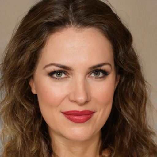 Joyful white young-adult female with long  brown hair and green eyes