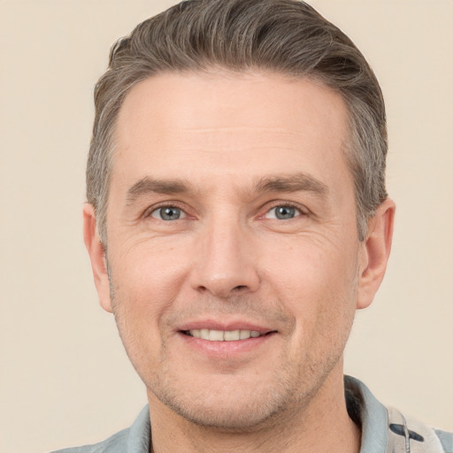 Joyful white adult male with short  brown hair and brown eyes