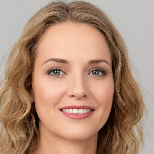 Joyful white young-adult female with long  brown hair and green eyes