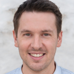 Joyful white adult male with short  brown hair and brown eyes