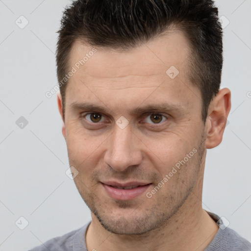 Joyful white adult male with short  brown hair and brown eyes