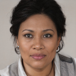 Joyful black adult female with medium  brown hair and brown eyes