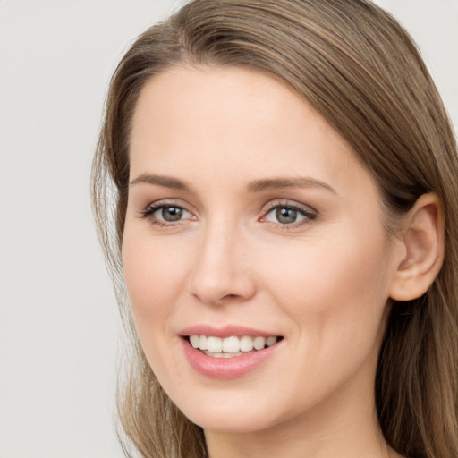 Joyful white young-adult female with long  brown hair and grey eyes