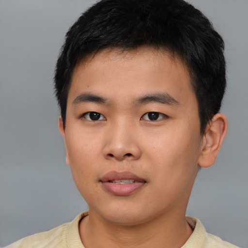 Joyful asian young-adult male with short  black hair and brown eyes