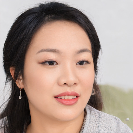 Joyful asian young-adult female with medium  black hair and brown eyes