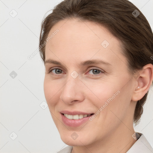 Joyful white young-adult female with short  brown hair and grey eyes