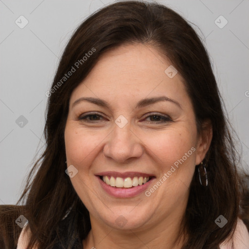 Joyful white adult female with long  brown hair and brown eyes