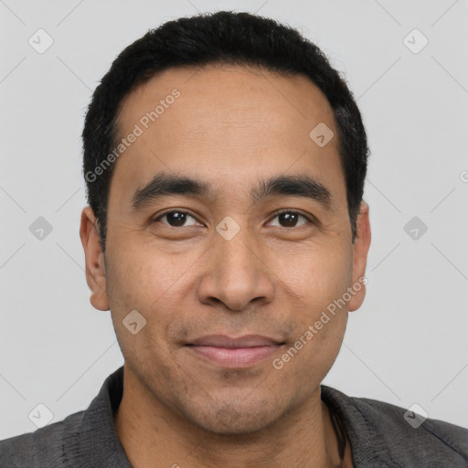 Joyful latino young-adult male with short  black hair and brown eyes